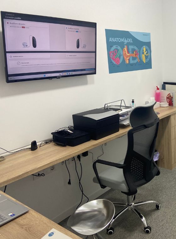 Sala de audición con apoyo digital y anatomía del oído en Auralis